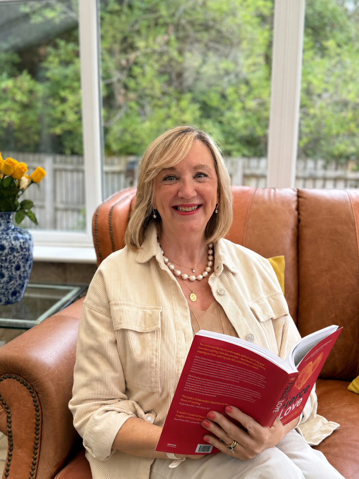 Marie Quigley seated with a copy of Fierce Love