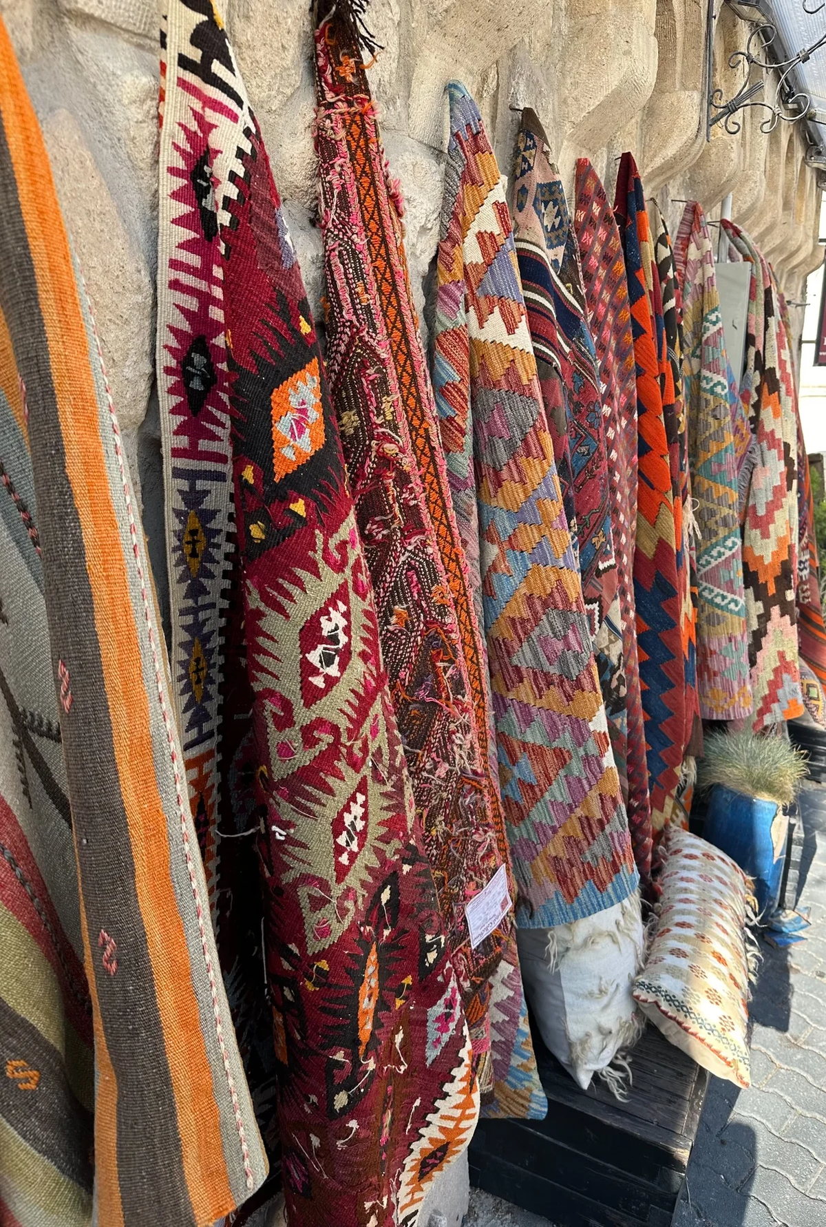 Colourful woven textiles hanging in a market